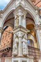 Detail of Palazzo Pubblico, main landmark in Siena, Italy photo