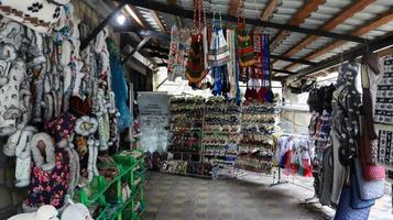 Souvenir market in Yaremche with traditional Carpathian handmade clothing, herbs and wooden tools. Ukrainian textiles, knitted socks, vests, hats. Ukraine, Yaremche - November 20, 2019 photo