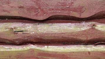 Walls from old planks painted brown, paneling overlapped each other as background. Abstract wooden background. The texture of the fence from unedged horizontal boards. Copy space, close-up. photo