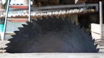 Old circular saw on wooden background with daylight. Carpentry work. Plunge saw blade for wood close up photo