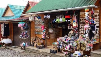 Souvenir market in Yaremche with traditional Carpathian handmade clothing, herbs and wooden tools. Ukrainian textiles, knitted socks, vests, hats. Ukraine, Yaremche - November 20, 2019 photo