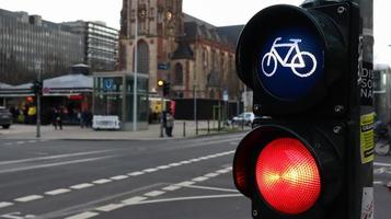 Dusseldorf, Germany - February 28, 2020. traffic light for bicycles close-up with a busy city in the background at a crossroads in Germany. Cyclists wait for a traffic light to cross the street.