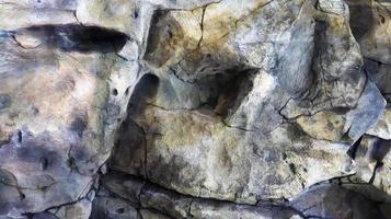 Stone rock texture or background. Gray rocky uneven surface, natural seamless backdrop for design. Copy space photo