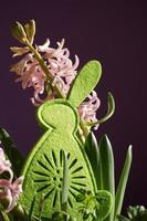 Decorative Green Easter Felt Bunny And Soft Pink Hyacinth Flowers. photo