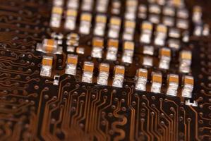 close up ceramic capacitors on electronic circuit board photo