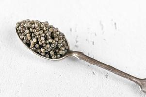 Spoon of black caviar photo