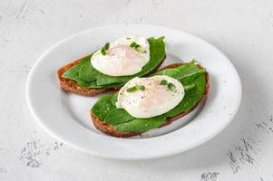 Sandwiches with spinach and poached egg photo