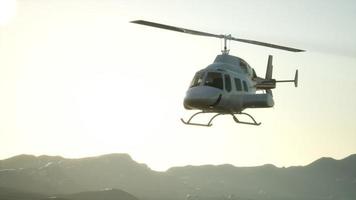 extreme slow motion flying helicopter and sunset sky