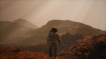 Spaceman walks on the red planet Mars. Space Mission video