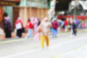 People at motion blur. Group of people walking open space. Defocused image photo