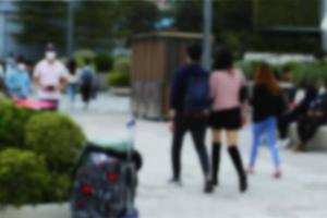 People at motion blur. Group of people walking open space. Defocused image photo