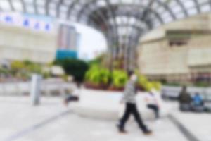 People at motion blur. Group of people walking open space. Defocused image photo