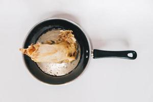 Raw stew beef bone soup in a pan isolated on white background. photo