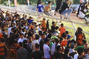 Gorontalo-Indonesia, March 2015 - Vocational school football fans cheering for their favorite team from the stands photo