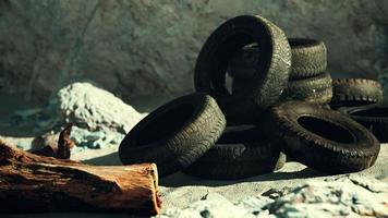 Old tire on the seashore and pollution of nature photo