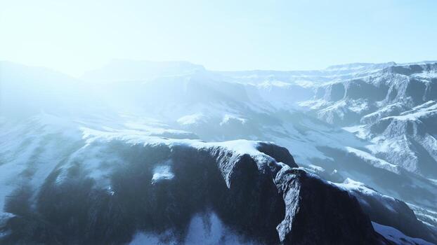 row of sharp dark cliffs standing out from the snow photo