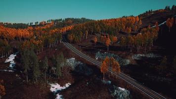 Aerial over a winding forest road in Finland during sunset photo