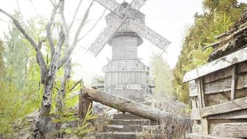 old traditional wooden windmill in the forest photo