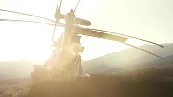 old rusted military helicopter in the desert at sunset photo