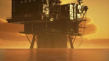 Offshore oil rig platform in sunset or sunrise time photo