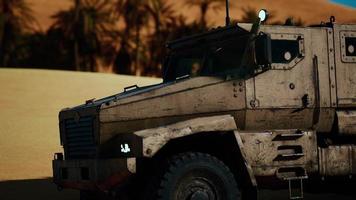 Armoured military truck in desert photo