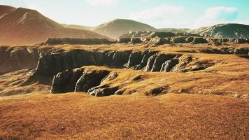 Grasslands wide panorama with autumn grass field and mountains photo