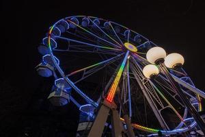 Ferris wheel beautifully illuminated at night in Leeds by the City Town Hall. photo