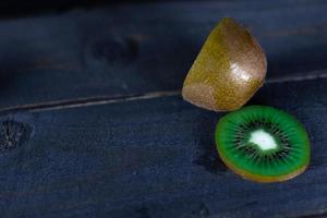 Kiwi fruit on wooden background with copy space photo