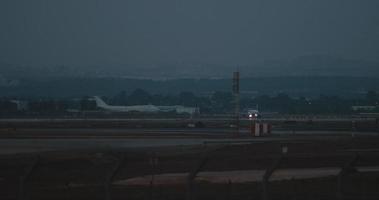 Plane moving on a runway of the airport with flashing lights, slow motion video