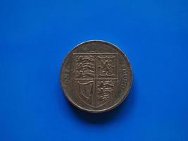 One Pound GBP coin, United Kingdom UK over blue photo