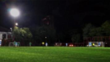 Defocused landscape football field at night with lighting. copy text space. photo