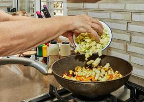 Toss the zucchini into the skillet to prepare the dish photo