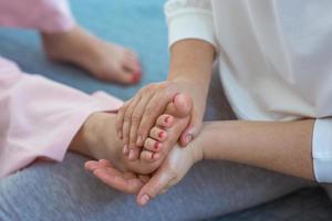 Hands making thai feet massage. Alternative medicine and thai massage concept photo