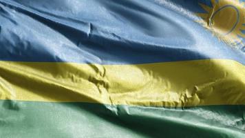 rwandas textilflagga vajar på vindslingan. rwandisk banderoll vajande på vinden. tyg textilvävnad. full fyllning bakgrund. 10 sekunders loop. video