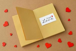 Red hearts, open book or open notepad, card with text with love. Love message, Valentine day concept photo