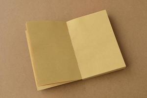 Open book. Notebook made on kraft brown paper, open blank pages notepad top view, mock up,copy space photo