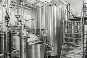 storage and pasteurization tank at the milk factory. equipment at the dairy plant photo