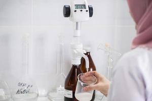 woman testing samples of dairy products in the laboratory. test laboratory of a milk factory photo
