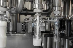 filling milk in to plastic bottles at the factory. equipment at the dairy plant photo