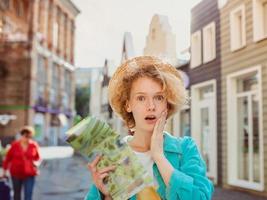 redhead young woman travel over West Europe and using paper map in unknown town. Travel photo. Lost in new city photo