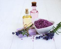 Heart-shaped bowl with sea salt, soap and fresh lavender flowers photo