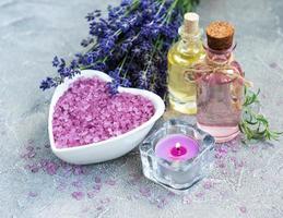 Heart-shaped bowl with sea salt and fresh lavender flowers photo
