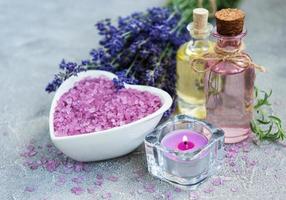 Heart-shaped bowl with sea salt and fresh lavender flowers photo