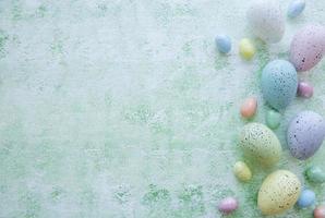 Colorful Easter eggs on green wooden background photo