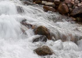 flow of a mountain river with rounded stones photo