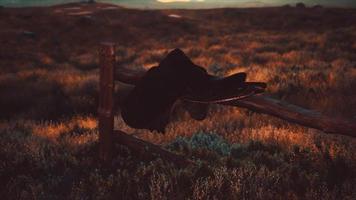 old saddle as the sunset in the country photo