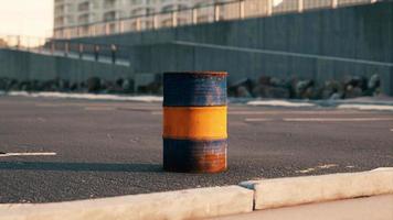 old and rusty metal barrel on parking photo