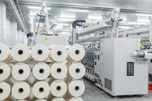 Machinery and equipment in the workshop for the production of thread. Interior of industrial textile factory photo
