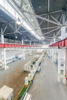 Plant for production and assembly of household refrigerators on the conveyor belt. factory workers collect refrigerators on the conveyor belt photo