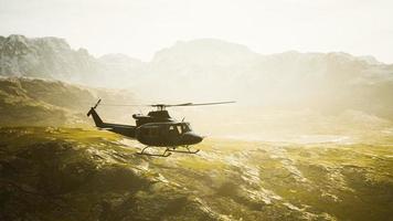 slow motion Vietnam War era helicopter in mountains photo